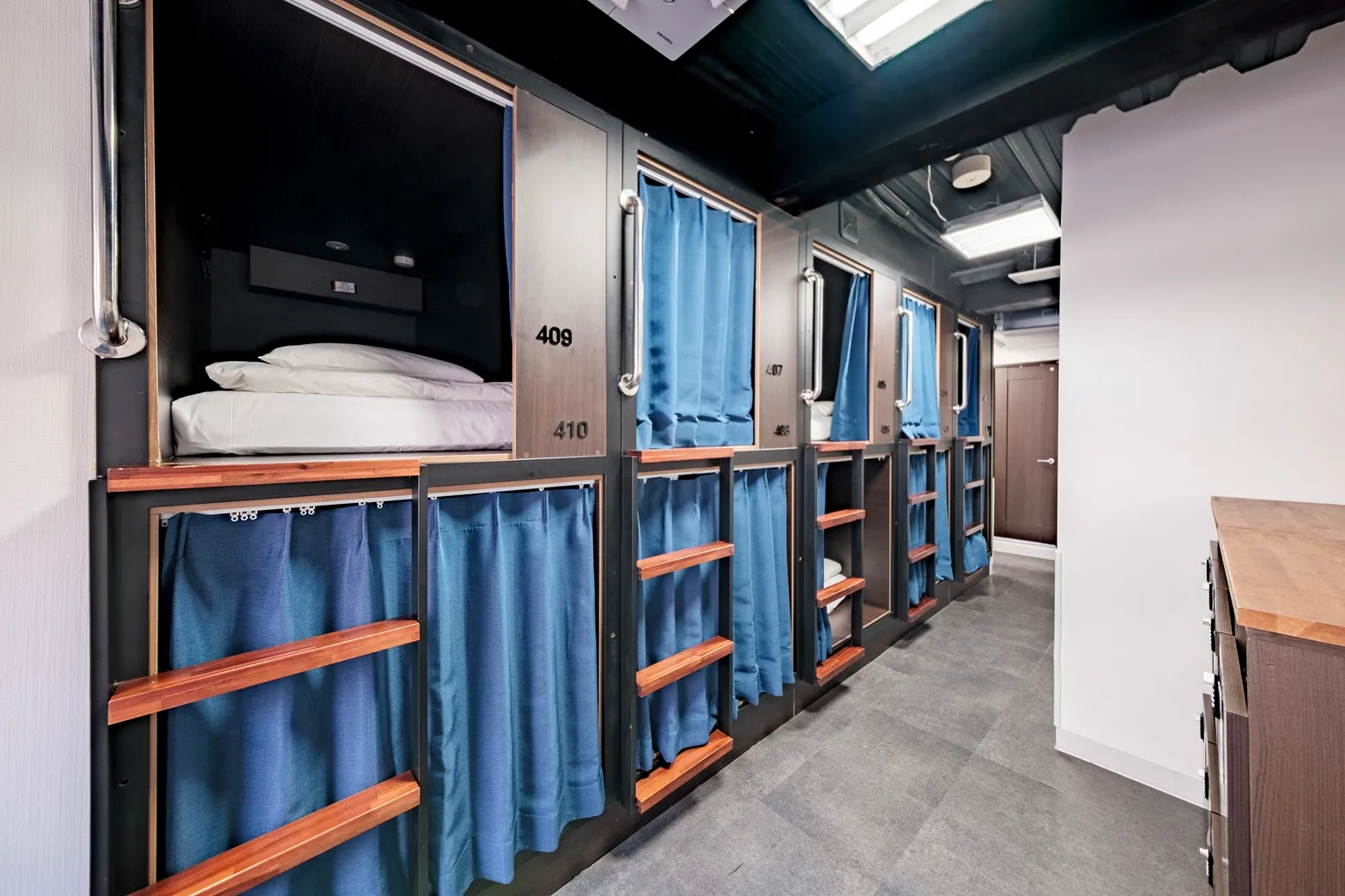 Mixed dormitory bunk bed with curtain at Hostel JAZ Ueno Tokyo